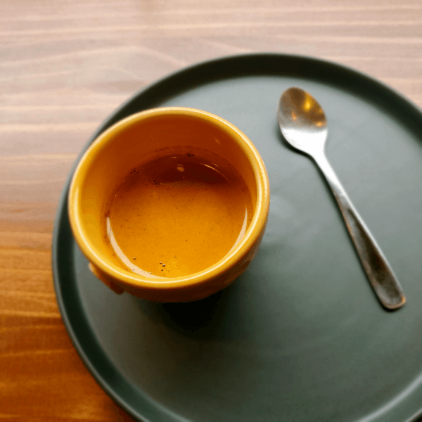 Espresso on a green ceramic plate